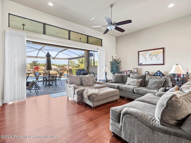 living room featuring dark hardwood / wood-style floors and ceiling fan