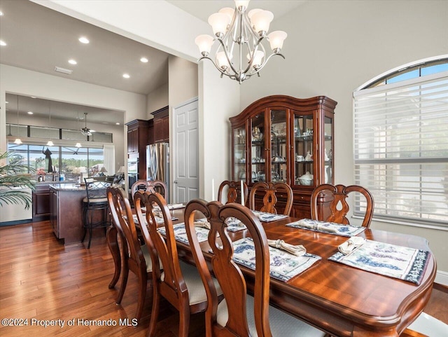 dining space featuring a notable chandelier and dark hardwood / wood-style flooring