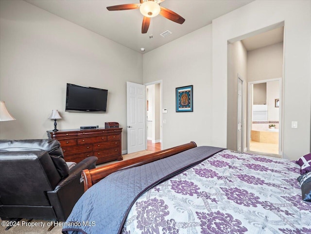 bedroom with ensuite bath and ceiling fan