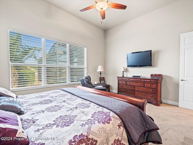 carpeted bedroom featuring ceiling fan, lofted ceiling, and multiple windows