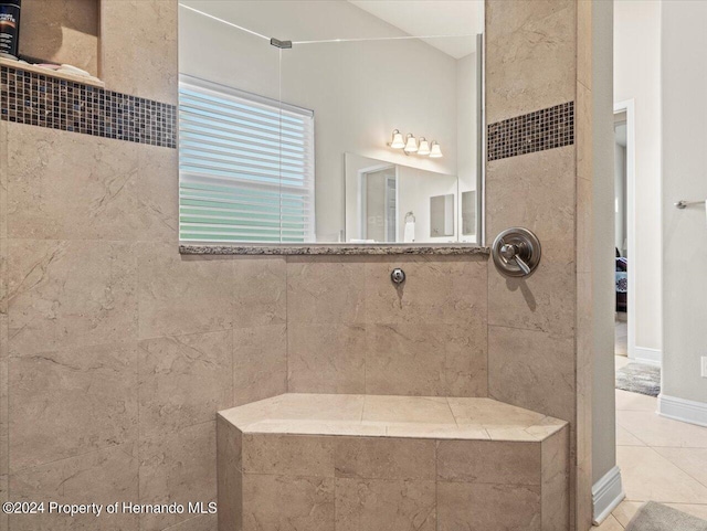 bathroom featuring a tile shower and tile patterned floors