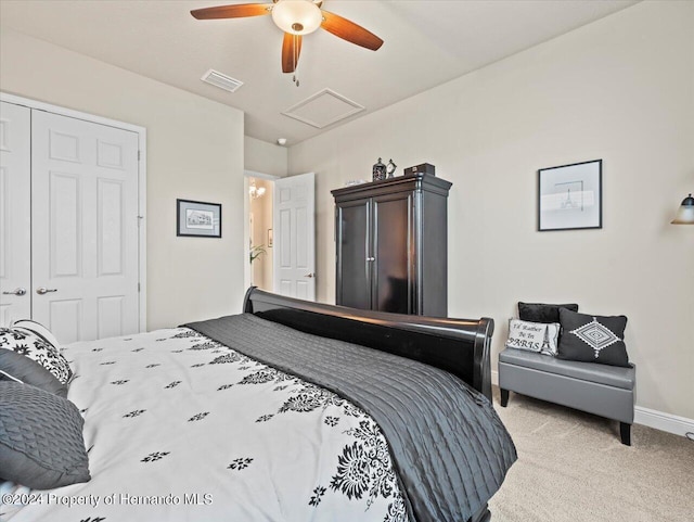 bedroom featuring ceiling fan, a closet, and light colored carpet