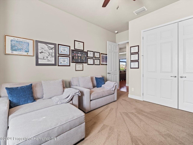 living room with light carpet and ceiling fan