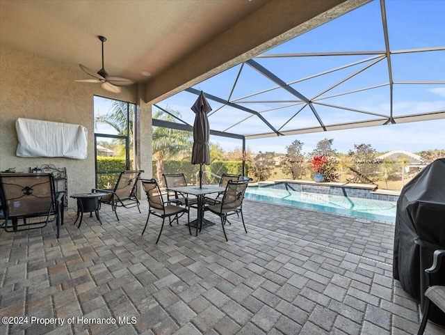 view of patio / terrace with ceiling fan, a lanai, and grilling area