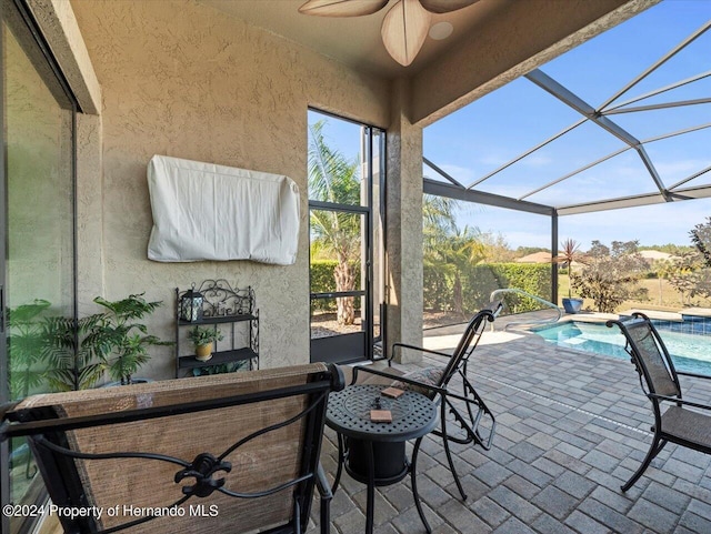 view of patio with a lanai and ceiling fan