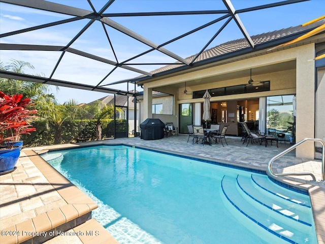 view of pool featuring a lanai, ceiling fan, and a patio