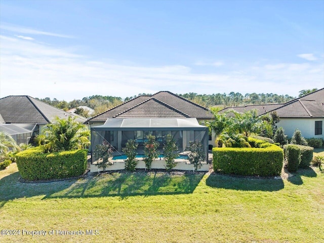 view of yard featuring glass enclosure and a pool