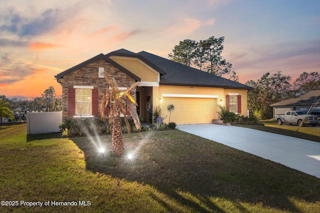 view of front of house featuring a garage and a yard