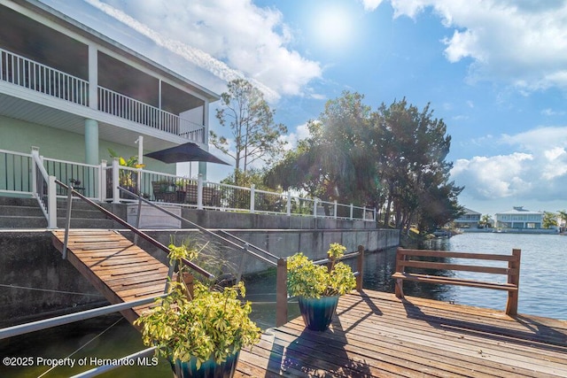 exterior space with a water view and a dock