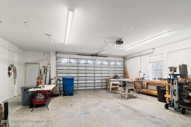 garage with a workshop area and a garage door opener