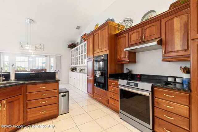 kitchen featuring double oven, stainless steel range with electric cooktop, sink, lofted ceiling, and light tile patterned flooring