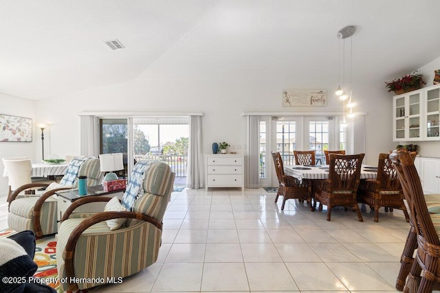 tiled dining area with french doors, vaulted ceiling, and a wealth of natural light