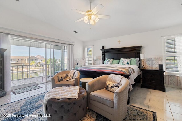 tiled bedroom with ceiling fan, vaulted ceiling, access to outside, and multiple windows