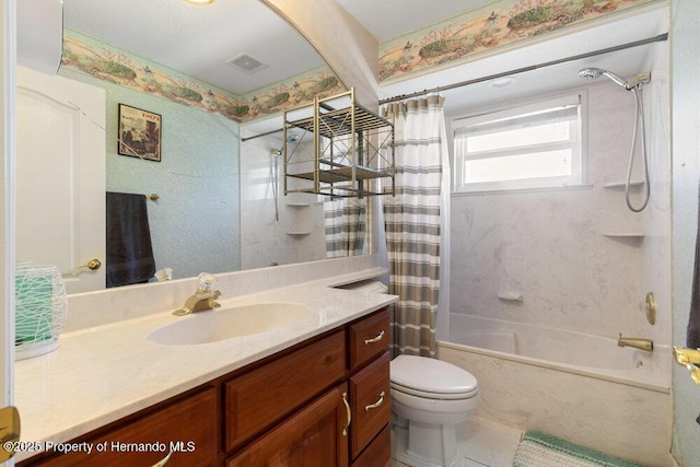 full bathroom with vanity, shower / bath combo, and toilet