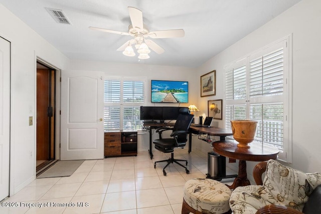 home office with ceiling fan and light tile patterned floors