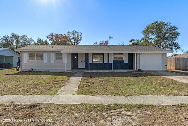 ranch-style home with a garage and a front lawn