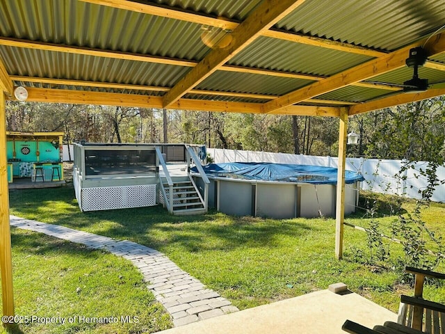 view of swimming pool with a yard and a deck