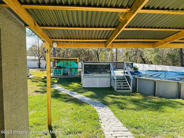 view of yard with a swimming pool side deck