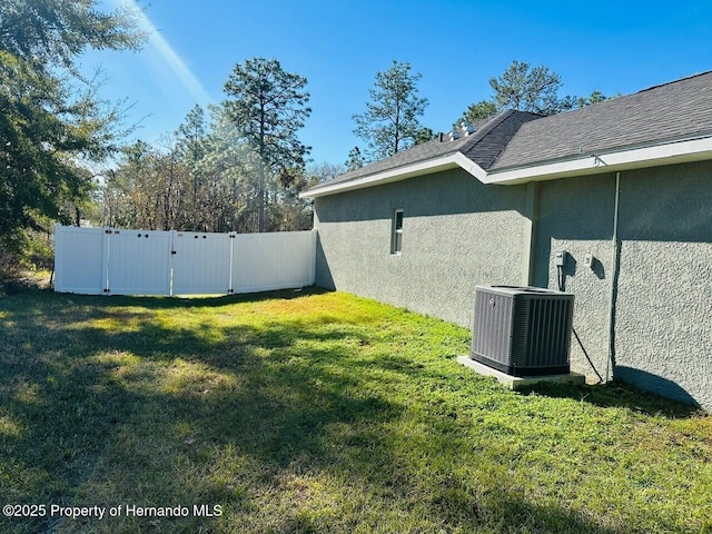 view of yard featuring central air condition unit