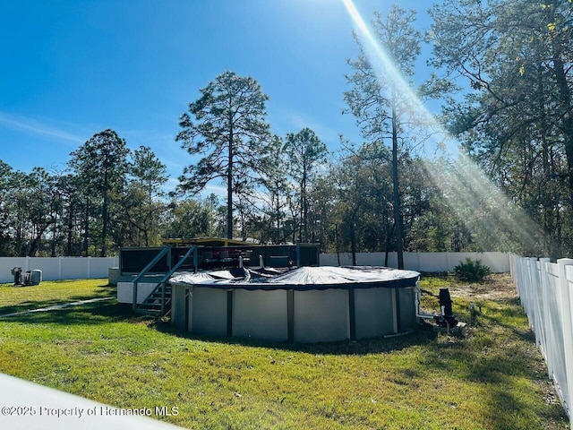 view of pool with a yard