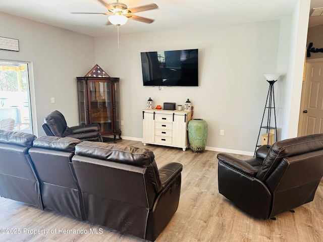 living room with ceiling fan and light hardwood / wood-style flooring