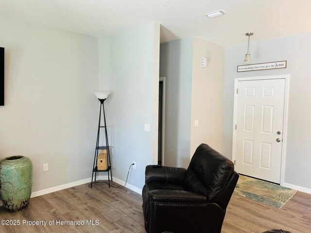 living area with hardwood / wood-style flooring