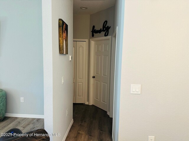 corridor with dark wood-type flooring