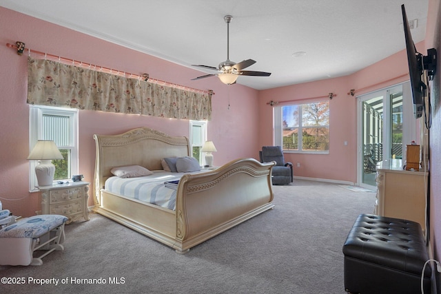 bedroom with carpet floors, ceiling fan, and access to exterior