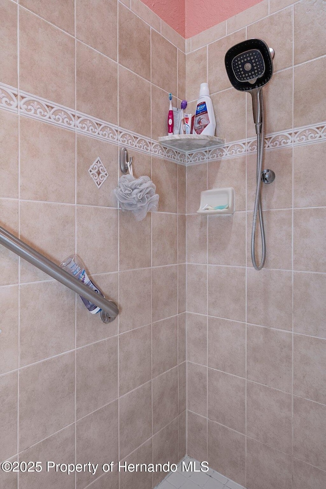 bathroom with a tile shower