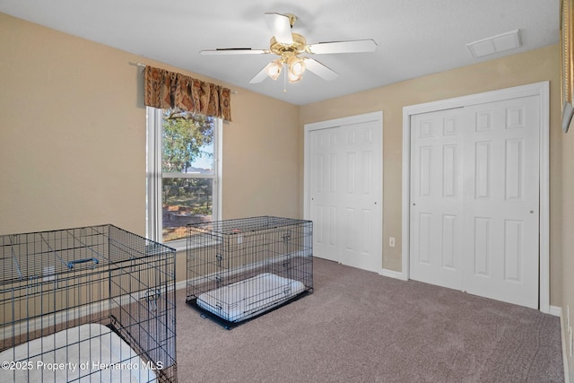 interior space with ceiling fan