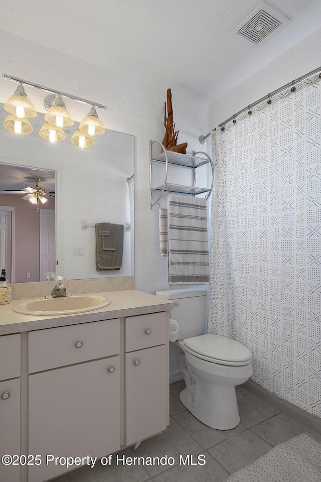 bathroom featuring toilet, ceiling fan, tile patterned floors, and vanity