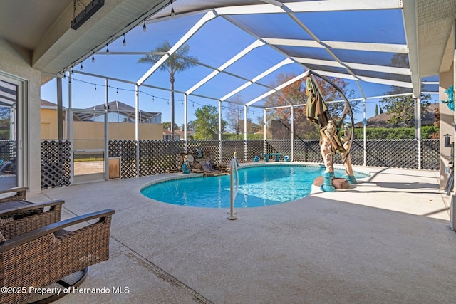 view of pool featuring a patio and glass enclosure