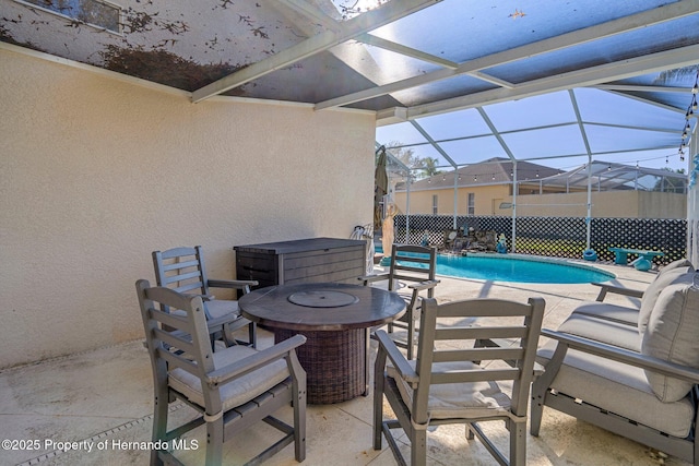 view of swimming pool featuring a patio area, a hot tub, and glass enclosure