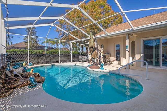 view of swimming pool featuring a lanai, a patio area, and ceiling fan