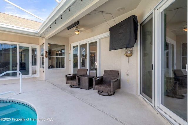 view of patio featuring ceiling fan