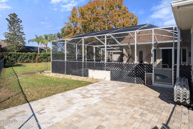 view of patio featuring a lanai