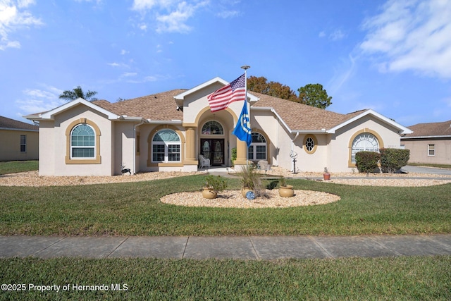 view of front of home featuring french doors and a front lawn