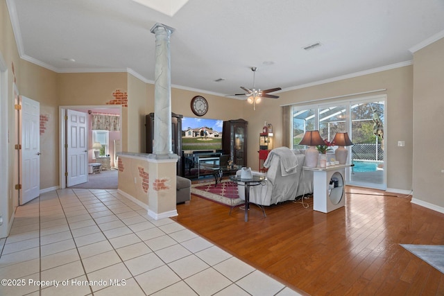 tiled living room with ornamental molding, ceiling fan, and ornate columns