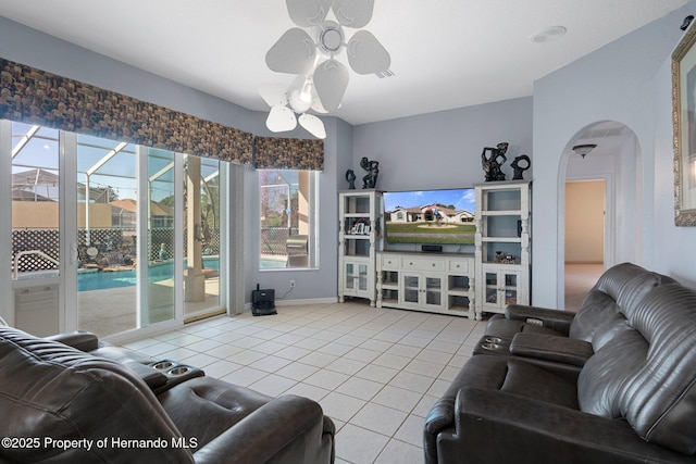 living room with ceiling fan and tile patterned flooring