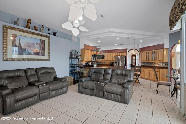 living room with ceiling fan and light tile patterned floors