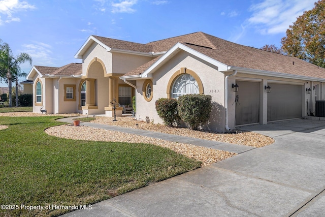 view of front of home featuring a garage and a front lawn