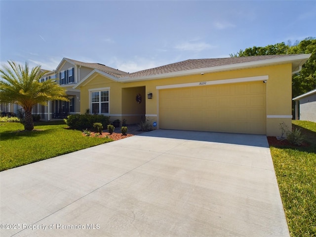 single story home featuring a garage and a front lawn