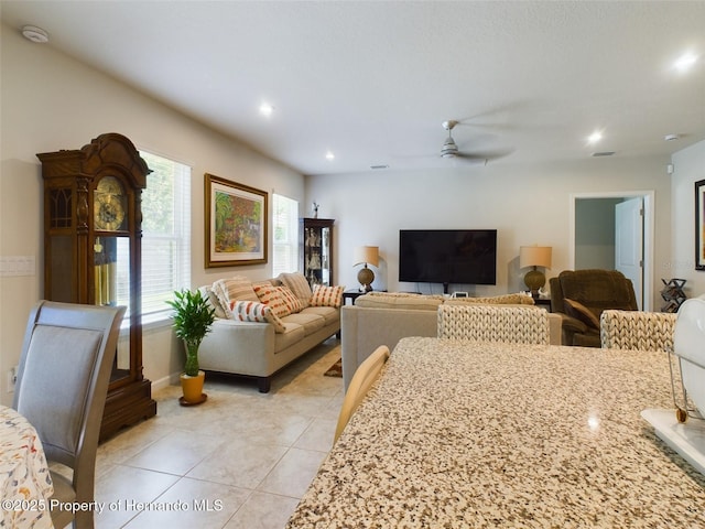 living room featuring ceiling fan, plenty of natural light, and light tile patterned floors