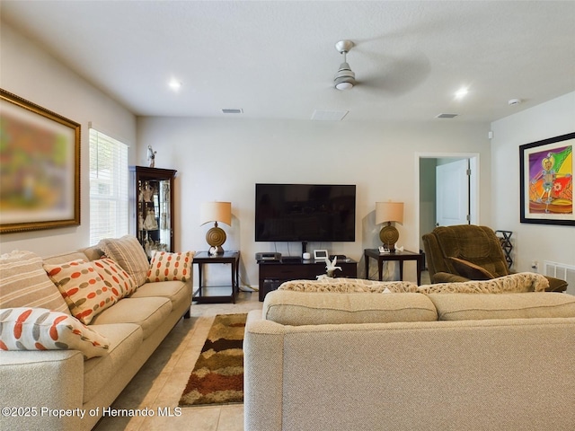 living room featuring ceiling fan and light tile patterned floors