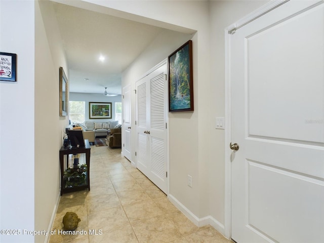 hall featuring light tile patterned floors