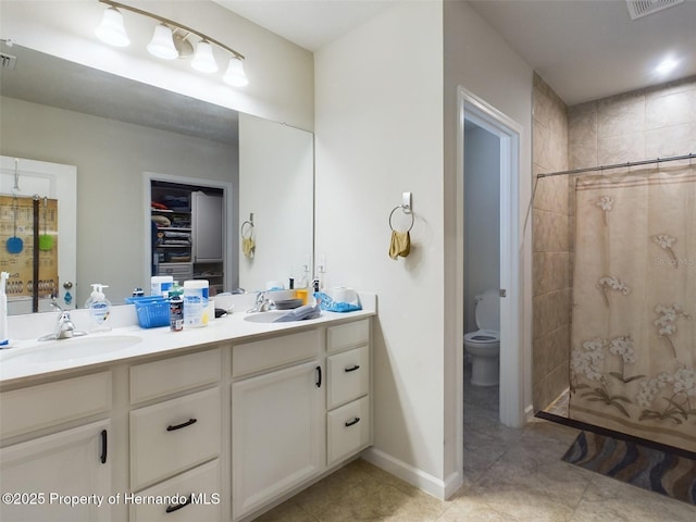 bathroom featuring toilet, vanity, and walk in shower