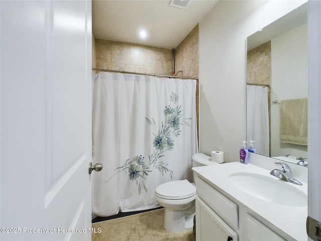 bathroom with toilet, vanity, and walk in shower