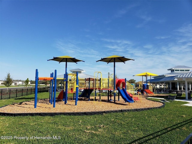 view of playground with a lawn