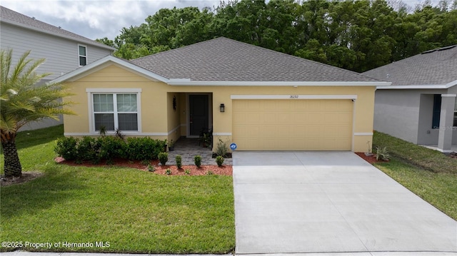 view of front of property featuring a front yard and a garage