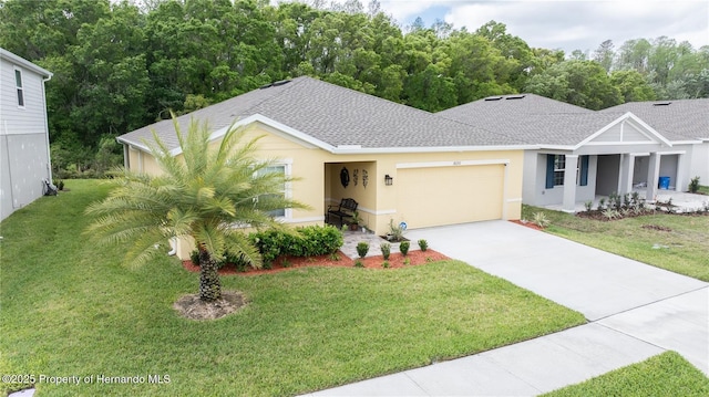 view of front of house featuring a garage and a front yard